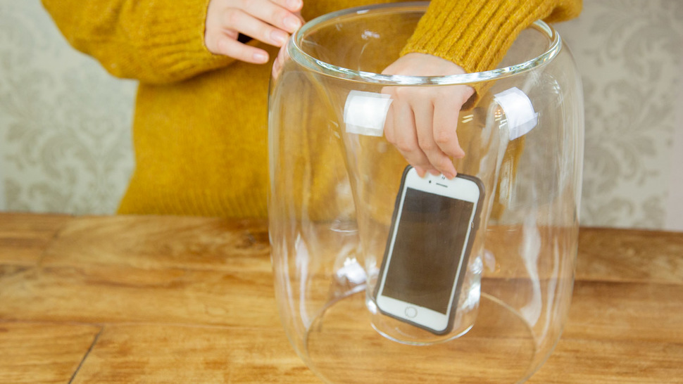woman-put-smartphone-in-the-speaker-on-the-table